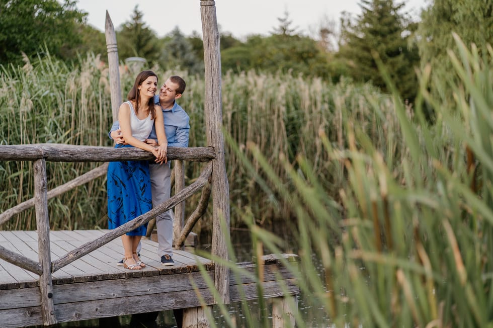 Fiatal pár stégen állva jegyesfotózás közben a völgyben Veszprémben.
